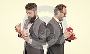 business partners on meeting isolated on white. bearded men hold valentines present. mature male businessmen in formal