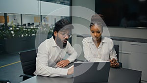 Business partners multiracial diverse company coworkers colleagues in office Indian man and African woman solving online