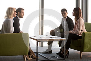 Business partners negotiate in conference room at briefing