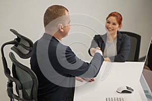 Business partners shake hands while concluding a deal. Deaf business man.