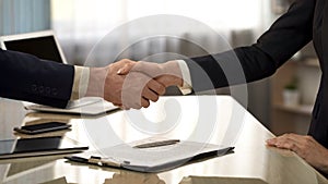 Business partners shaking hands after contract signing, companies cooperation