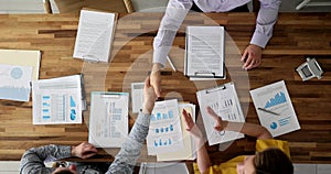 Business partners shaking hands at table in office top view 4k movie slow motion