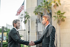 Business partners shaking hands. Two businessmen shaking hands outdoor. Business mens growth strategy. Business men with