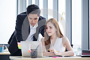 business partners team working together on desk with laptop and document . Businessman using laptop computer and businesswoman