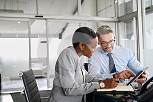 Business partners working on digital tablet in modern office