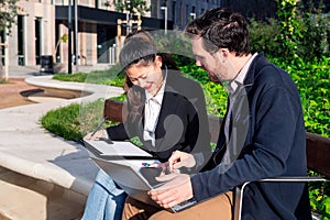 business partners working outdoors with a laptop