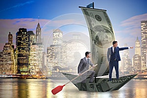 The business partnership with businessmen sailing on dollar boat