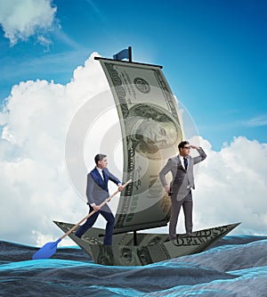 Business partnership with businessmen sailing on dollar boat