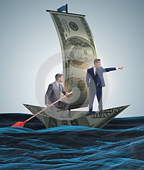 Business partnership with businessmen sailing on dollar boat