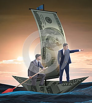 The business partnership with businessmen sailing on dollar boat