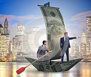Business partnership with businessmen sailing on dollar boat