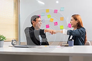 Business partnership concept, Business senior making fist bump with partner after successful work