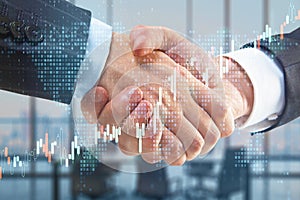 Business partnership with double exposure of handshaking men and abstract financial graphs