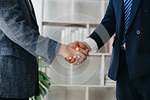Business partnership handshake concept.Photo two coworkers handshaking process.Successful deal after great meeting. in office