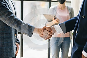 Business partnership handshake concept.Photo two coworkers handshaking process.Successful deal after great meeting. in office