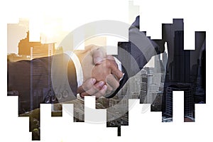 Business partnership successful concept, Double explosure businessman handshake on Abstract city view Backgorund