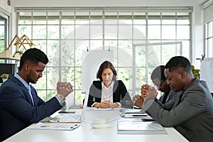 Business partnership team pray to spiritual growth for successful of business during meeting.