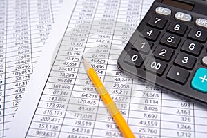 Business pen, calculator and glasses on financial chart, business concept.