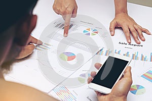 Business people analyst team during discussing financial review, point finger at graph document,after big BOSS vi