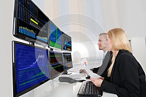 Business People Analyzing Data Displayed On Computer Screens