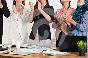 Business people applauding in a business meeting.