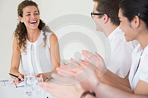 Business people applauding for businesswoman