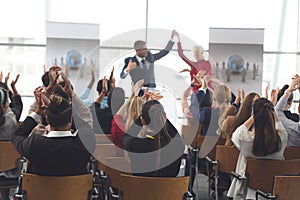 Business people applauding and celebrating in a business seminar