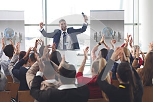 Business people applauding and celebrating in a business seminar