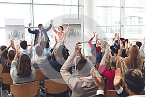 Business people applauding and celebrating in a business seminar