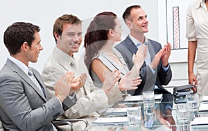 Business people applauding a colleague