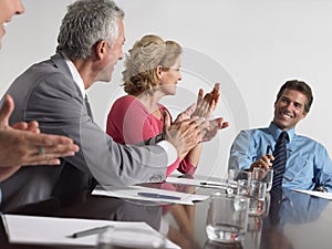 Business People Applauding In Conference Room