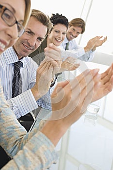Business People Applauding In Conference Room