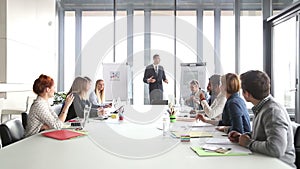 Business people applauding director during a meeting