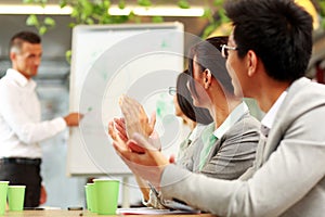 Business people applauding in a meeting