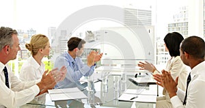 Business people applauding at a meeting