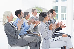 Business people applauding during meeting