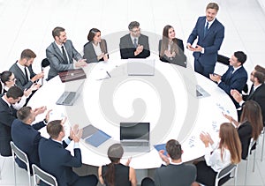 Business people applauding speaker at a business meeting.