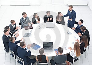 Business people applauding speaker at a business meeting.