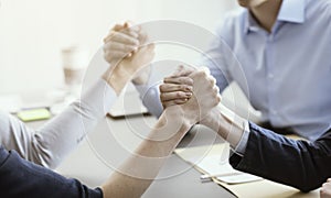 Business people arm wrestling in the office