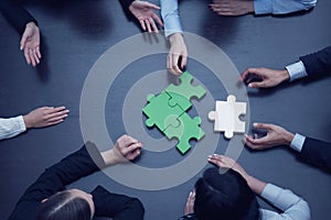 Business people assembling puzzle