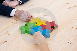 Business people assembling puzzle