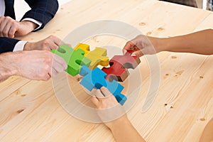 Business people assembling puzzle