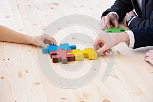 Business people assembling puzzle