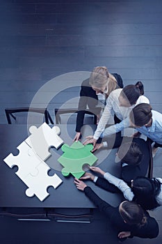 Business people assembling puzzle