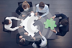 Business people assembling puzzle