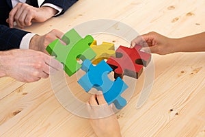 Business people assembling puzzle