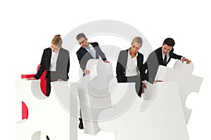 Business people assembling puzzle