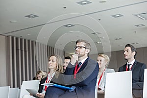 Business people attending seminar in convention center