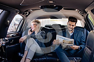 Business people at back seat of limo