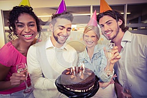 Business people with birthday cake enjoying the party